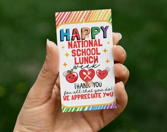 May include: A rectangular card with the text "HAPPY NATIONAL SCHOOL LUNCH WEEK" in colorful letters. Below are illustrations of an apple, a heart with a fork and spoon, and a heart. The card also says "THANK YOU for all that you do! WE APPRECIATE YOU".