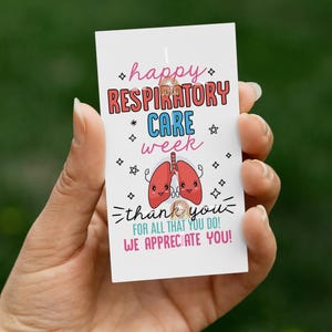 May include: A white card with the text "happy RESPIRATORY CARE week" in pink and blue, along with a cartoon lung graphic. The card also says "thank you for all that you do! We appreciate you!"