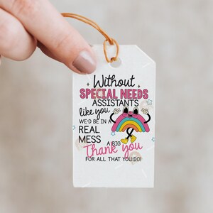 May include: A white gift tag with a brown string, featuring the text "Without Special Needs Assistants like you, we'd be in a real mess. Thank you for all that you do!" A cartoon rainbow is also on the tag.
