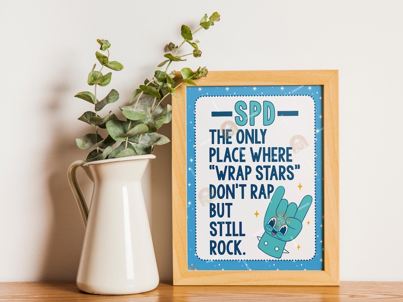 May include: A framed print with the text "SPD - The only place where 'wrap stars' don't rap but still rock." The print has a blue border with white stars and a cartoon hand making a rock-and-roll gesture.