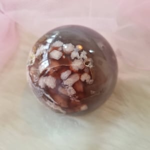 Black flower agate sphere with red and pink flowers