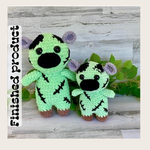 May include: Two handmade crochet monster dolls. The dolls are light green with black patches, black noses, and stitched details. They have purple ears and brown feet. The text "Finished product" is on the left side.