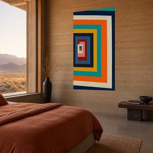 Könnte beinhalten: Ein rechteckiges Wandkunstwerk mit einer Reihe ineinander verschachtelter, konzentrischer Quadrate in leuchtenden Farben wie Orange, Türkis, Marineblau, Gelb, Rot, Rosa und Weiß, die ein geometrisches Muster mit Tiefenwirkung erzeugen.