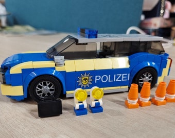 Police patrol car made of clamping blocks, printed bricks and cardboard packaging, police car for children, City clamping blocks