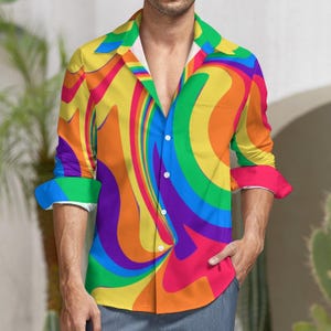 May include: A long-sleeved button-down shirt with a colorful rainbow swirl pattern. The shirt has a relaxed fit and a collar.