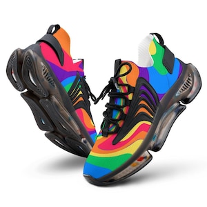 May include: A pair of colorful sneakers with a rainbow design. The shoes feature a black sole and laces, with a vibrant mix of red, orange, yellow, green, blue, and purple hues. The design is eye-catching and modern.