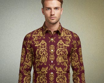 May include: A burgundy button-down shirt with a gold baroque pattern. The long-sleeved shirt has a classic collar and is buttoned up. The shirt is paired with dark blue pants.