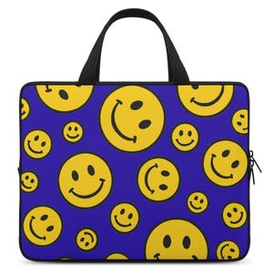 May include: A laptop bag with a vibrant blue background covered in yellow smiley faces of various sizes. The bag has a black handle and zipper, offering a cheerful and playful design. The bag is designed to carry a laptop.