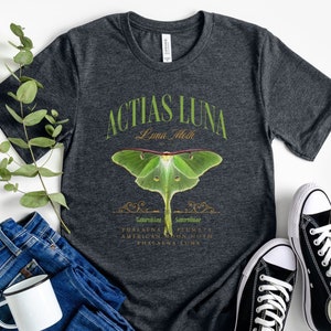 May include: Dark grey heather t-shirt with a green luna moth illustration and the text "Actias Luna Luna Moth" in a vintage style font.