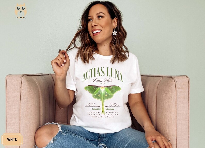 May include: White t-shirt with a green Luna Moth graphic and the text "Actias Luna Luna Moth Est. 1758" and "Phalana Plumata American Moon Moth Phalana Luna".