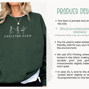 May include: A dark green sweatshirt with a white graphic of three skeletons dancing. The text "Skeleton Crew" is printed below the graphic.
