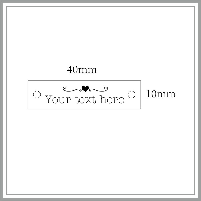 May include: A white rectangular label with a black heart and decorative swirls. The label is 10 cm long and 4 cm wide. The text on the label reads "Your text here".