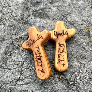 May include: Two wooden crosses with rounded edges, engraved with names and inspirational phrases. One cross reads "Wendy, I am fearfully and wonderfully made." The other says "Jody, You are the light of the World."
