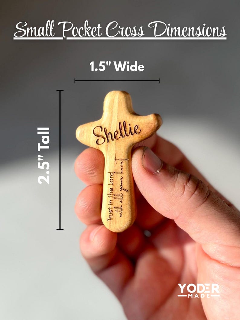May include: A small, wooden pocket cross with the name "Shellie" engraved on it. The cross is 2.5 inches tall and 1.5 inches wide. The text "Trust in the Lord with all your heart" is also engraved on the cross. The words "Small Pocket Cross Dimensions" are at the top.