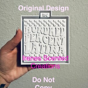 May include: White silicone mold with a checkered pattern and the text "HUNDRED PERCENT LATINA" in a pink, wavy font. The mold also includes the text "Irenes Scented Creations" and "Do Not Copy".