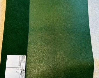 May include: A rectangular piece of forest green leather with a textured grain surface and a smooth suede underside. A white label is attached to the corner with the printed text COLOR, SHADE, QUANTITY and the handwritten entry GREEN FOREST 50.