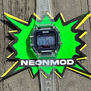 May include: A digital wristwatch with a clear, transparent plastic strap and a rectangular case. The watch face features a black background with the text SKMEI, ALARM CHRONOGRAPH, and WATER 50M RESIST. The digital display shows the time 11:16:33.