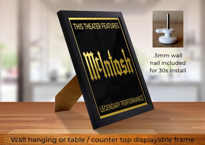 May include: Black framed print with gold text that reads "This Theater Features McIntosh Legendary Performance". The frame has a stand for tabletop display and a nail for wall hanging.