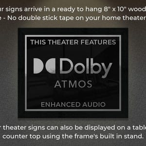 May include: A black framed sign with the text "This Theater Features Dolby Atmos Enhanced Audio". The sign is 8 inches by 10 inches and is ready to hang on a wall.