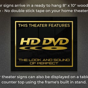 May include: A black framed sign with gold lettering that reads "This Theater Features HD DVD The Look and Sound of Perfect". The sign is 8 inches by 10 inches and is ready to hang on a wall.