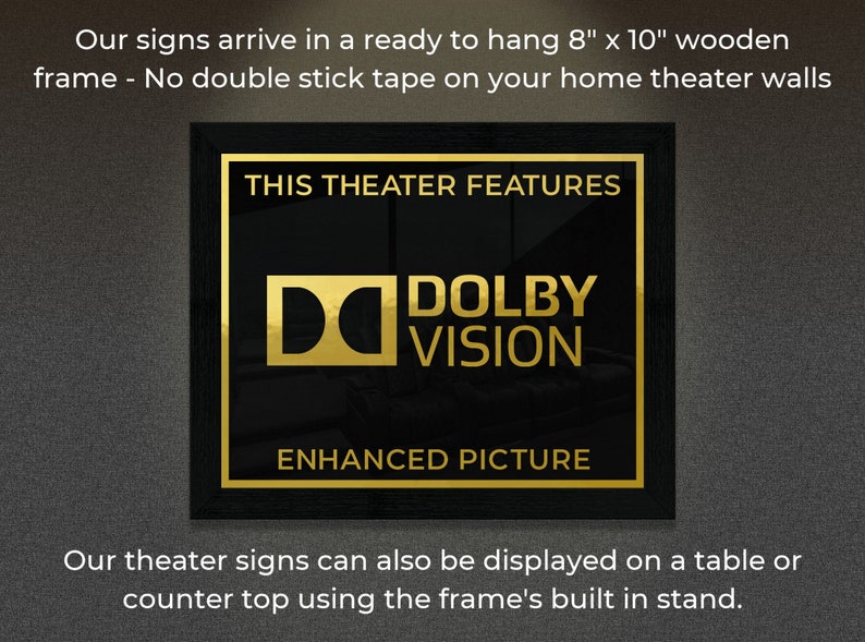 May include: A black framed sign with gold lettering that reads "This Theater Features Dolby Vision Enhanced Picture". The sign is 8 inches by 10 inches and is ready to hang.