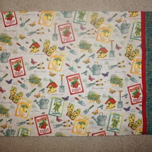 May include: A rectangular pillowcase with a gardening theme. The main pattern features gardening tools, seed packets, butterflies, and birdhouses on a light background. A red stripe and a green patterned border are on the right side.