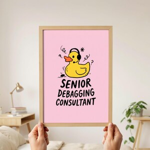 Funny programmer wall art featuring a yellow rubber duck wearing headphones with the text Senior Debugging Consultant. Computer science desk decor.