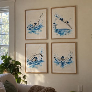 Op de afbeelding: Een set van vier ingelijste kunstprints met aquarelillustraties van zwemmers in blauwtinten. De prints tonen verschillende zwemslagen en een duiker op een startblok met het nummer vier, allemaal gevat in lichtgekleurde houten lijsten.