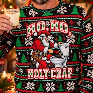 May include: A black long-sleeve crewneck sweater featuring a festive knit pattern of red and green stripes, snowflakes, and Christmas trees. The center graphic depicts Santa Claus fixing a toilet with the text HO HO HOLY CRAP.