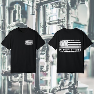May include: Two black t-shirts with a distressed American flag design in white. The text "PIPEFITTERS" is below the flag. One shirt has the design on the chest, the other on the back. The shirts are short-sleeved.