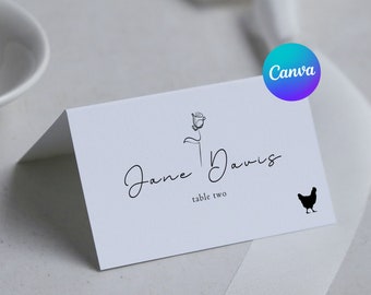 May include: White place card with black text and a simple line drawing of a rose. The text reads "Jane Davis" and "table two". A black silhouette of a chicken is in the bottom right corner.
