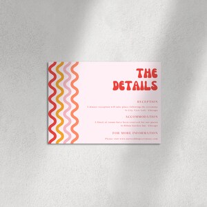 May include: A pink and white wedding invitation with a wavy red, orange, and yellow design on the left side. The text "THE DETAILS" is in red with a retro font. The text includes information about the reception and accommodation. The text reads: "RECEPTION A dinner reception will take place following the ceremony At City View Loft Chicago ACCOMMODATION A block of rooms have been reserved for our guests At Hilton Garden Inn Chicago FOR MORE INFORMATION Please visit www.ourweddingceremony.com"