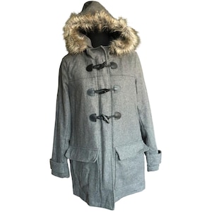 May include: A gray duffel coat with a faux fur-lined hood. The coat features black toggle closures, two front pockets, and a tailored fit. The hood is trimmed with brown and tan faux fur.