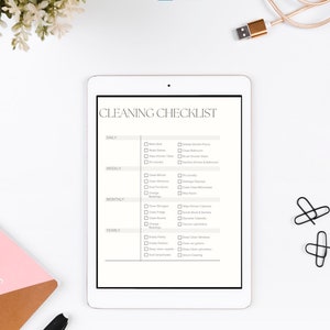 May include: A white tablet displaying a cleaning checklist. The checklist is organised into four sections: daily, weekly, monthly, and yearly. Each section contains a list of cleaning tasks with checkboxes next to them.