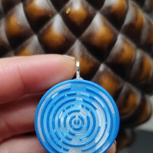 Vibrant blue/pearl spiral with frequency chips inside