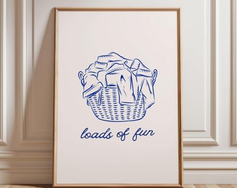 May include: A white poster with a blue illustration of a laundry basket overflowing with clothes. The text "loads of fun" is written below the basket.
