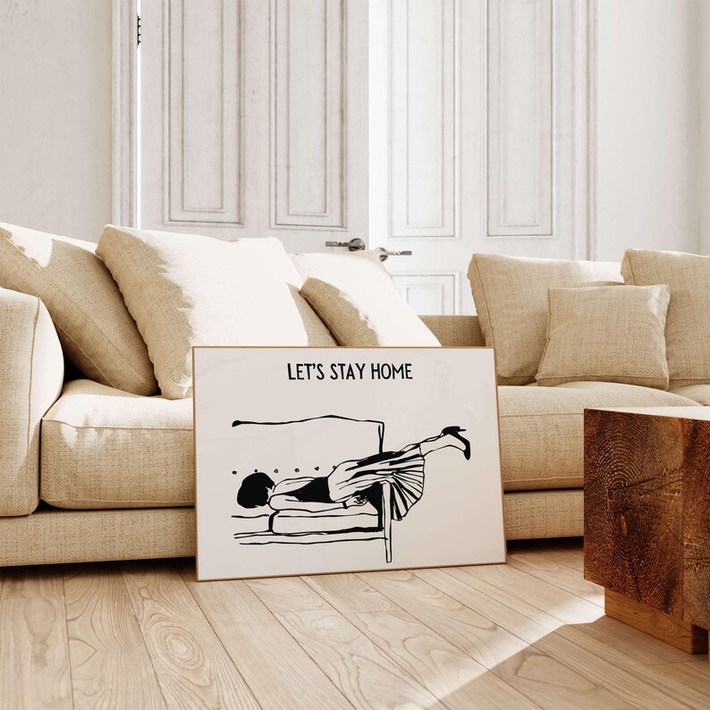 May include: Black and white illustration of a person lying upside down on a couch with the text "Let's Stay Home".