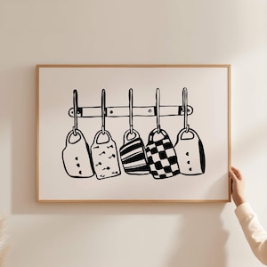 May include: Black and white line drawing of five mugs hanging on a rack. The mugs have different patterns, including stripes, polka dots, and a chequered pattern.
