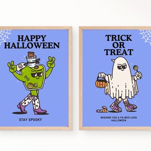 Peut inclure: Deux affiches encadr&eacute;es sur le th&egrave;me d'Halloween. L'une repr&eacute;sente une potion verte avec le texte "HAPPY HALLOWEEN" et "STAY SPOOKY". L'autre montre un fant&ocirc;me avec un bonbon et une citrouille, avec le texte "TRICK OR TREAT" et "WISHING YOU A FA-BOO-LOUS HALLOWEEN."