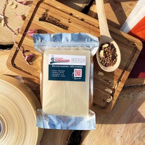 May include: A rectangular package of clear collagen casing for sausage making, featuring a label with the text "Колагенова оболонка" and a QR code. The product is presented alongside a wooden spoon filled with mixed peppercorns and spices.