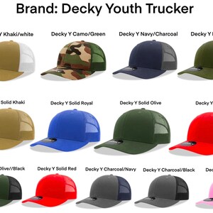 May include: A collection of 12 youth trucker hats in various colors and patterns. The hats are all made by Decky and feature a mesh back.