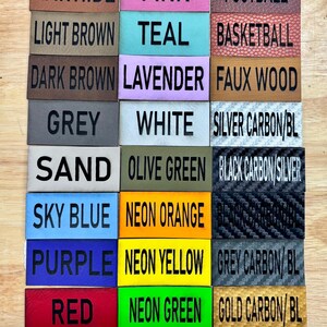 May include: A collection of 18 leather and fabric swatches with color and texture names printed on each. The swatches include colors like rawhide, pink, teal, lavender, white, olive green, sky blue, neon orange, purple, neon yellow, red, and neon green.  The swatches also include textures like football, basketball, faux wood, silver carbon, black carbon, and grey carbon.