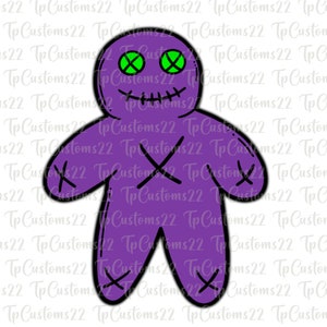 May include: A purple voodoo doll with green eyes and an X stitched on each limb. The doll has a stitched mouth and a stitched nose.