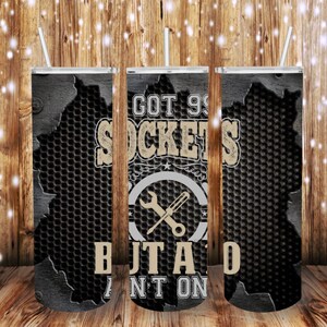 May include: Three stainless steel tumblers with a black and gray metal pattern. The center tumbler has the text "GOT 99 SOCKETS BUT A DAD AINT ONE" in white and a wrench and screwdriver graphic.