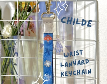 May include: A blue and white wrist lanyard keychain with a gold clasp. The lanyard features a repeating pattern of a character from the video game Genshin Impact, along with dice and other symbols. The text "CHILDE WRIST LANYARD KEYCHAIN" is written on a white background behind the lanyard.