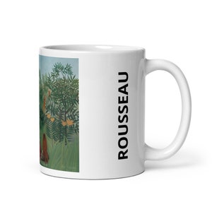 May include: White ceramic mug with a colorful painting of a jungle scene and the word "ROUSSEAU" printed on the side.