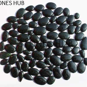 May include: A collection of 50 green aventurine gemstone cabochons in various sizes and shapes. The stones have a sparkly, glittery appearance.