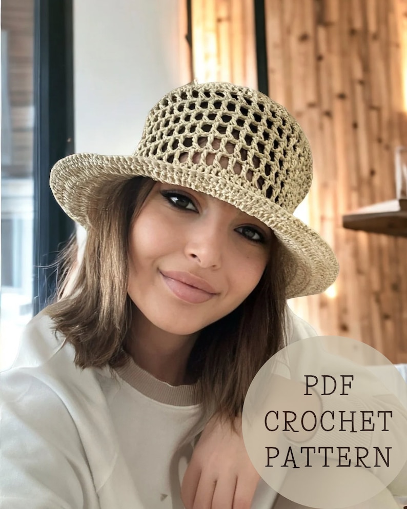 May include: A crochet hat pattern in PDF format. The hat is beige and has a wide brim. The pattern is for a crocheted hat with an open weave.