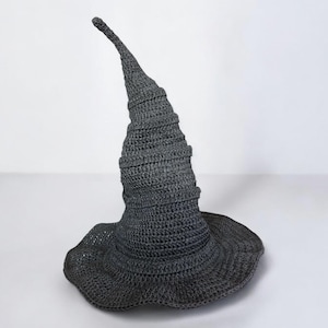 May include: A gray crocheted witch hat with a tall, pointed crown and a wide brim.