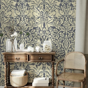 May include: A room with a wooden console table, a woven basket, and a rattan chair. The wallpaper features a repeating pattern of stylized rabbits and foliage in navy blue and cream. The table has two drawers.